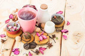 Tea cups with teapot on old wooden table