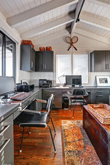 Classic large bright home office interior with modern and antiqu