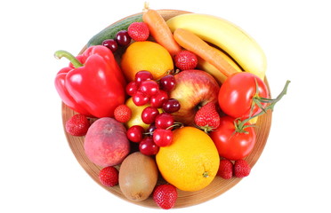 Fresh fruits and vegetables on wooden plate