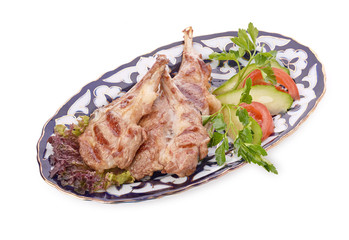 Meat on a grill with vegetables