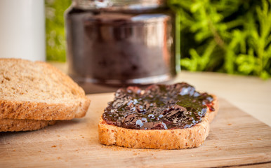 breakfast with sour cherry marmalade on toast with a glass of milk and frutis