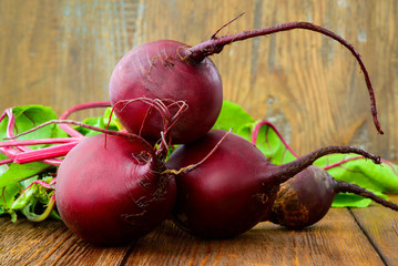 Young Raw Organic Red Beets on wooden table