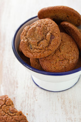 cookies in bowl on white wooden background