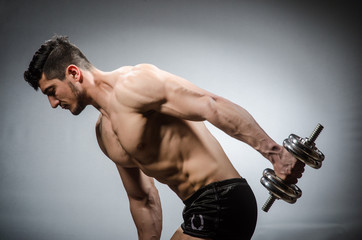 Muscular ripped bodybuilder with dumbbells