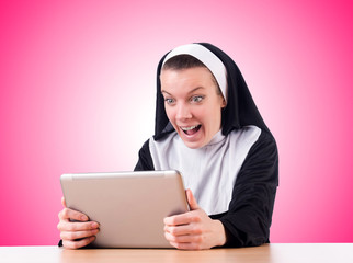 Nun working on laptop - religious concept