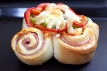 Obraz na płótnie Canvas Pizza rolls with vegetables, ham and cheese.