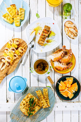 Grilled Fruit and Seafood Dishes on Rustic Table