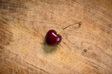 Ripe cherry on wooden plank