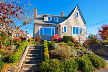 Large traditional house with shrubbery.