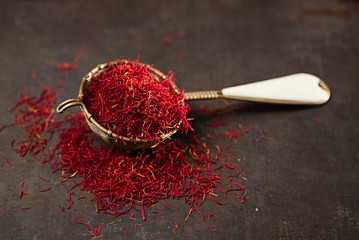 saffron spice threads and powder  in vintage  old sieve
