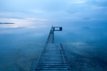 Optical illusion, a bathing jetty seem to float in the air when the sea meets the sky on a magical summer evening at the island of Gotland, Sweden
