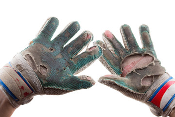 Old Torn Gloves and Hands of the Soccer Goalkeeper Isolated on