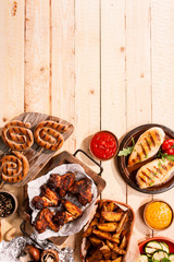 Grilled Meats and Vegetables on Wooden Table