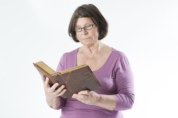 Elderly woman reading a book..