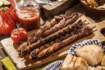 Grilled Meat Skewers Surrounded by Other Dishes