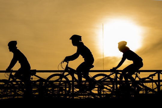silhouette of biker on Bridge and sunset