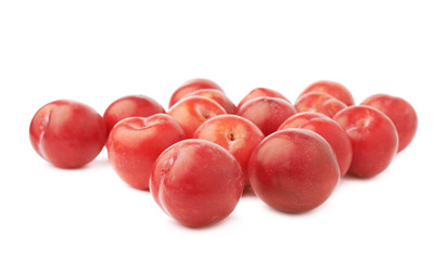 Pile of multiple red plums isolated