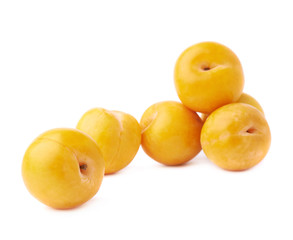 Pile of multiple yellow plums isolated
