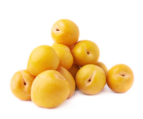 Pile of multiple yellow plums isolated