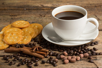 Cup of coffee on a wooden board and biscuits