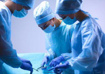 Team surgeon at work in operating room.