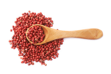 Spoon over the red pepper seeds isolated