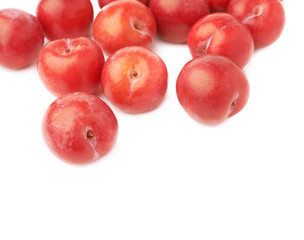 Pile of multiple red plums isolated