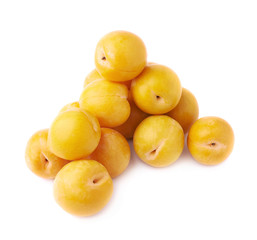 Pile of multiple yellow plums isolated