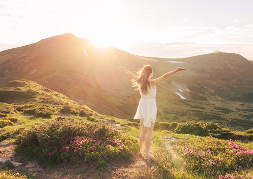 Happy woman enjoying the nature in the mountains