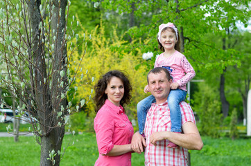 Fototapeta premium happy family plays a parka with a child