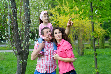 Fototapeta premium happy family plays a parka with a child