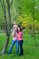 Fototapeta premium happy family plays a parka with a child