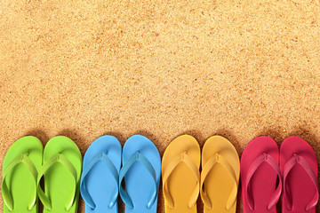 Row line border of flip flops flipflop summer beach sandals on a sand background team teamwork...