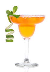 Orange Margarita cocktail with mint and lime spiral in chilled s