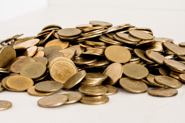 Stack of golden Thai coins isolated on white background