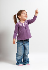 Cute little girl pointing up