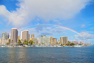 Rainbow over Waikiki beach resort and marina in Honolulu, Hawaii, USA. 