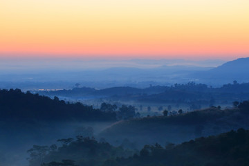 Obraz premium Colorful autumn landscape in the mountain village. Foggy morning at sunlight time