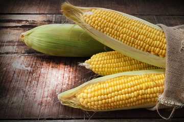 fresh corn on wooden table