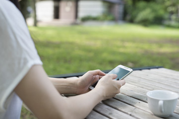Women are relaxing with a cup of coffee in the garden