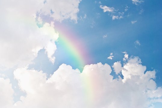 image of blue sky and white clouds with rainbow