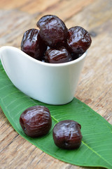 Red date - sugar preserved fruit on wood background
