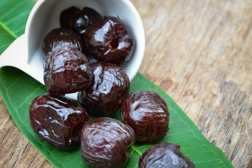 Red date - sugar preserved fruit on wood background