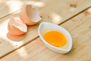 Raw egg on wooden table