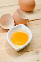 Raw egg on wooden table