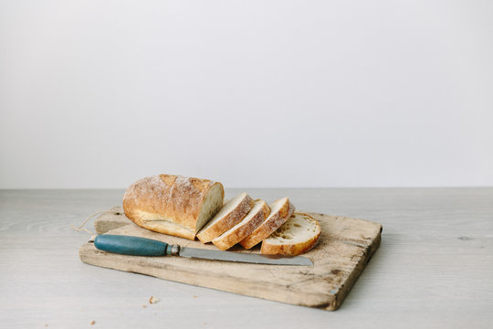 Close-up of a Loaf of white sourdough bread sliced on a chopping board