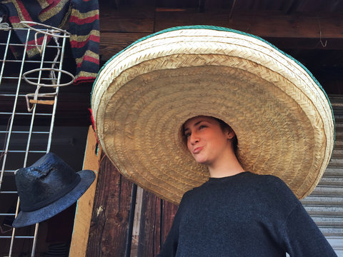 Girl Wearing A Giant Sombrero In A Market, Mexico