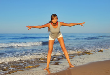 Healthy woman doing exercising on the beach, girl doing sport ou