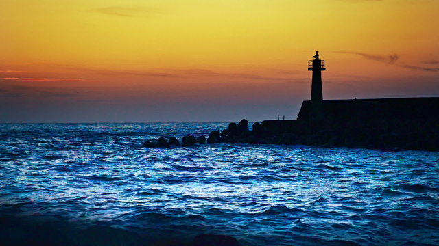 lighthouse under sunburst