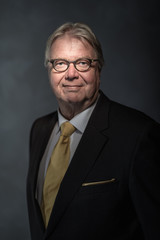 Senior businessman on dark background